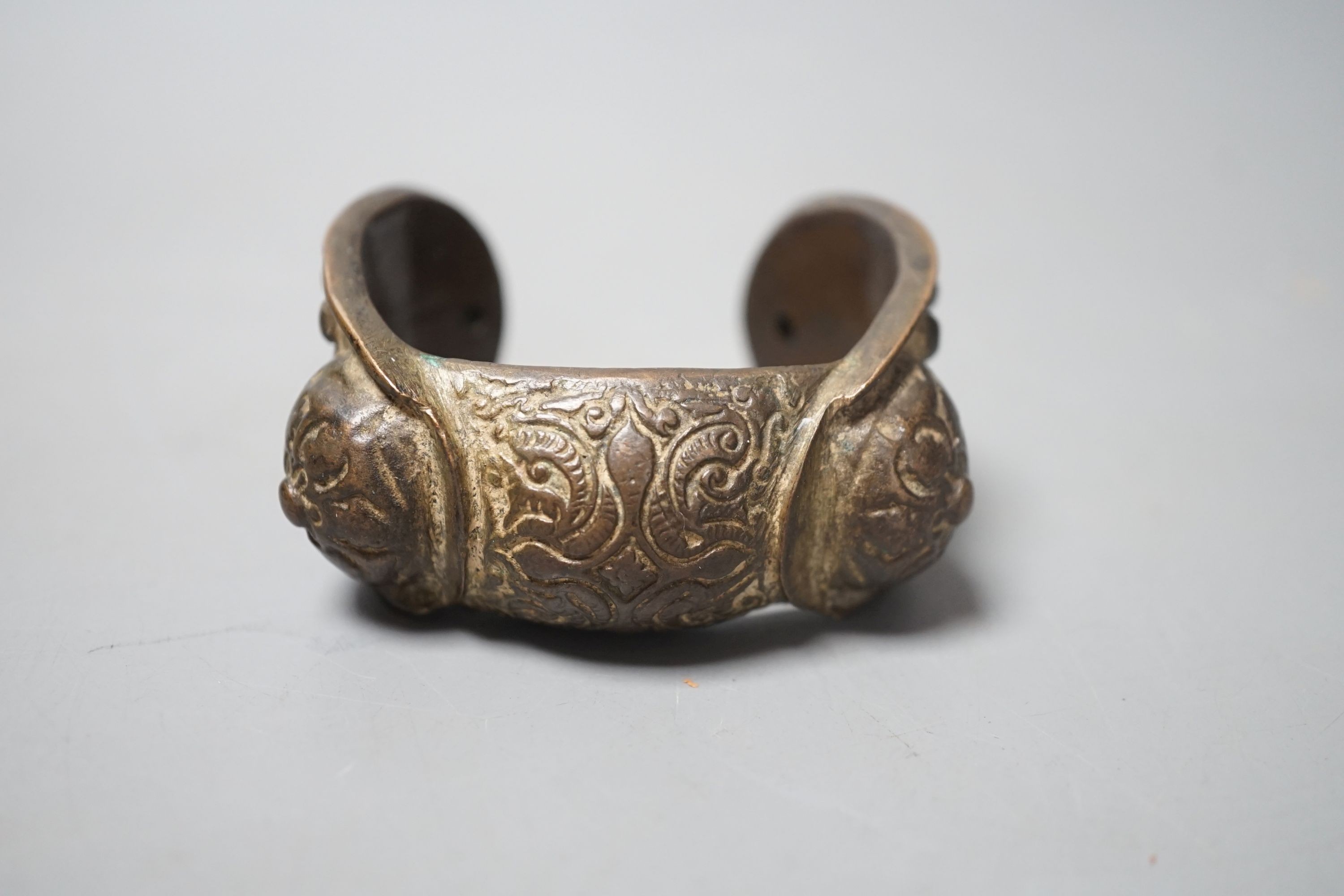 A Chinese brass bangle